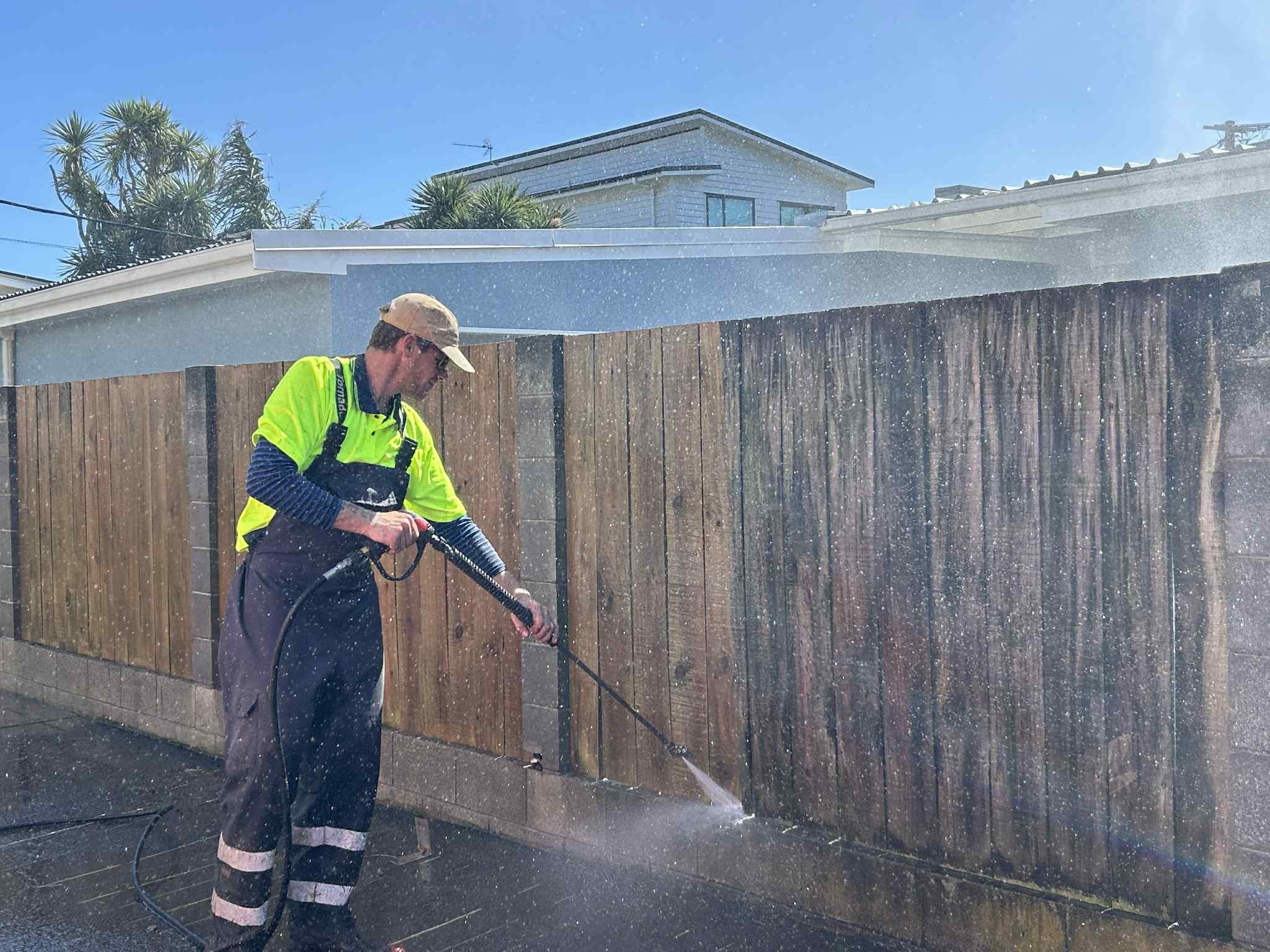 Awa Wash crew pressure washing a driveway